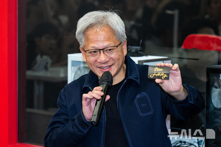 [서울=뉴시스] 조성우 기자 = 젠슨 황 엔비디아 최고경영자(CEO)가 5일 서울 마포구 'T1 베이스 캠프'에서 '페이커' 이상혁을 비롯한 e스포츠 구단 T1의 리그 오브 레전드(LoL) 선수단을 만나서 추첨을 통해 선물할 엔비디아의 ‘RTX 스파크’를 들어 보이고 있다. (공동취재) 2026.06.05. photo@newsis.com