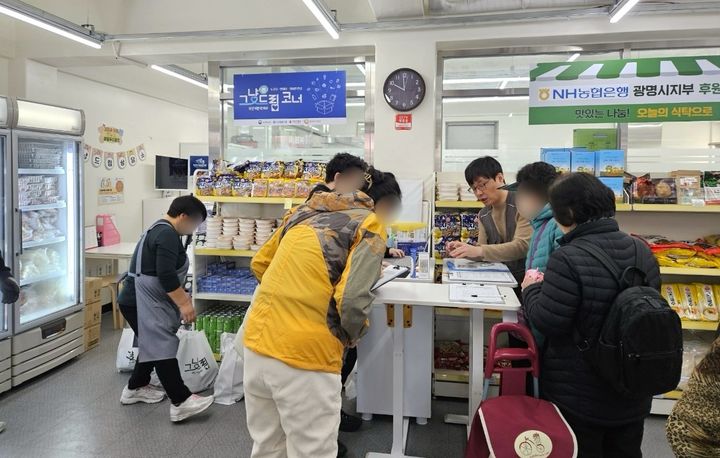 [광명=뉴시스] 광명푸드뱅크마켓센터 직원들이 그냥드림 코너에서 식료품 꾸러미를 배부하고 있다. (사진=광명시 제공) 2026.06.09. photo@newsis.com *재판매 및 DB 금지