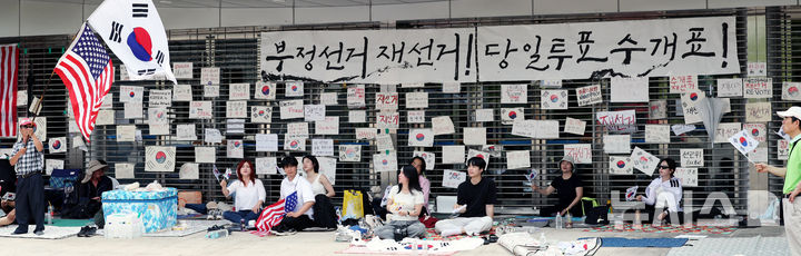[서울=뉴시스] 박주성 기자 = 제9회 전국동시지방선거 투표용지 부족 사태에 항의하며 개표소 봉쇄 시위를 이어가고 있는 14일 서울 송파구 올림픽공원 핸드볼경기장에 설치된 개표소 앞에서 시민들이 구호를 외치고 있다. 2026.06.14. park7691@newsis.com