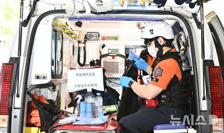 [수원=뉴시스] 김종택 기자 = 무더운 날씨를 보인 지난 16일 경기 수원시 권선구 수원남부소방서 권선119안전센터 구급대원들이 온열 질환자 발생에 대비해 구급 차량 내 얼음조끼와 아이스팩 등 폭염대비 물품을 점검하고 있는 모습. 2026.06.16. jtk@newsis.com