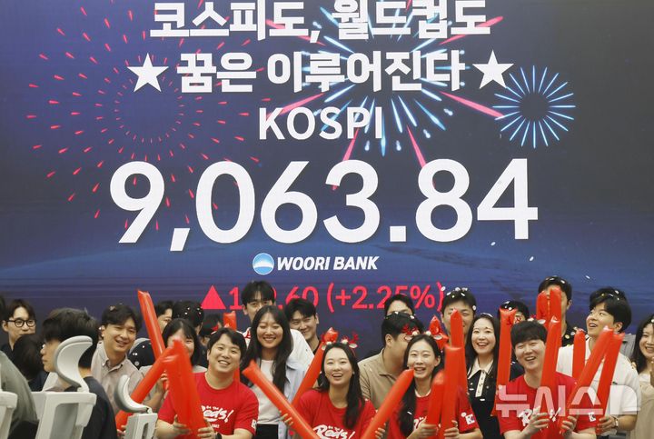 [서울=뉴시스] 김혜진 기자 = 코스피가 사상 처음으로 9000을 돌파한 18일 오후 서울 중구 우리은행 본점 딜링룸에서 직원들이 축하 세리머니를 하고 있다. 2026.06.18. jini@newsis.com