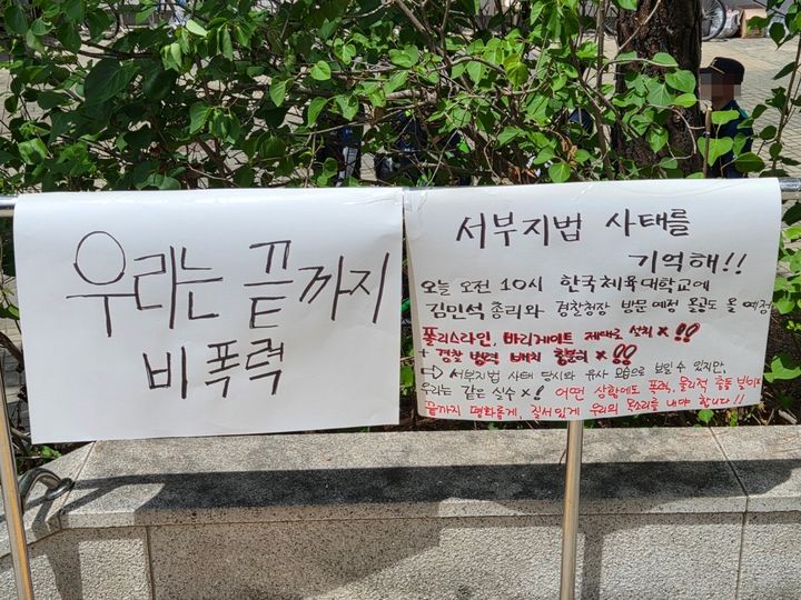 [서울=뉴시스] 이태성 기자 = 21일 오전 서울 송파구 올림픽공원 핸드볼경기장 일대에 게시된 종이 팻말. 인근 한체대에서 개최 예정인 총리 참석 토론회로 인한 무력 충돌을 우려하는 모습이다. 2026.06.21. victory@newsis.com *재판매 및 DB 금지