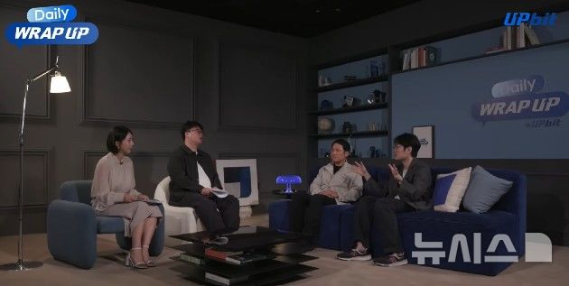 [서울=뉴시스]디지털자산 거래소 업비트 운영사 두나무가 운영 중인 유튜브 콘텐츠 '데일리 랩업'(Daily WRAP UP) 영상 한 장면. 거시경제와 디지털자산 시장을 아우르는 콘텐츠를 제공한다. (사진=메리츠증권 제공) 2026.06.25. photo@newsis.com 