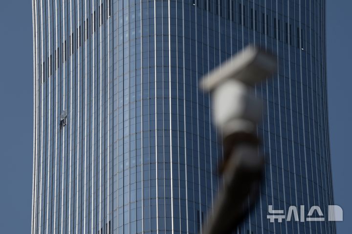 [베이징=AP/뉴시스] 중국 베이징 최고층 건물인 '중국존(中國尊)'에 경비행기가 충돌해 추락한 사고 이후 중국 당국이 수도권 공역에 역대 가장 강력한 수준의 비행 통제 조치를 시행할 것이라는 전망이 제기됐다. 27일 중국존 건물 인근에 설치된 감시카메라의 모습. 2026.06.29