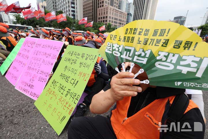 [서울=뉴시스] 이영환 기자 = 민주노총 조합원들이 15일 오후 서울 종로구 동화면세점 앞에서 열린 민주노총 7.15 총파업대회에 참석해 피켓을 들고 있다. 2026.07.15. 20hwan@newsis.com