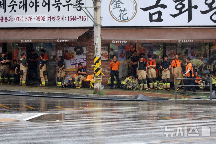 [인천=뉴시스] 고승민 기자 = 지난 18일 오전 화재가 시작된 인천 서해구 석남동 쿠팡32물류센터 앞 식당에서 20일 오전 소방대원들이 비를 피하고 있다. 2026.07.20. kkssmm99@newsis.com