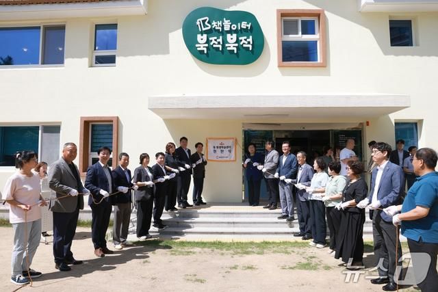 [울산=뉴시스] 23일 오전 울산 동구 서부동 '책 놀이터 북적북적'에서 열린 동구 제1호 동 평생학습센터 현판 제막식에서 동구 관계자들이 기념사진을 촬영하고 있다.(사진=울산 동구 제공) photo@newsis.com *재판매 및 DB 금지