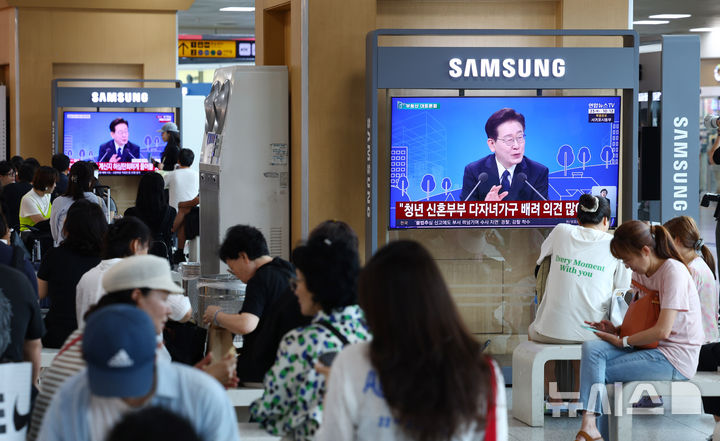 [서울=뉴시스] 전신 기자 = 23일 서울 용산구 서울역 대합실에서 시민들이 이재명 대통령이 주재하는 '부동산 정책 국민 대토론회' 생중계를 시청하고 있다. 2026.07.23. photo1006@newsis.com