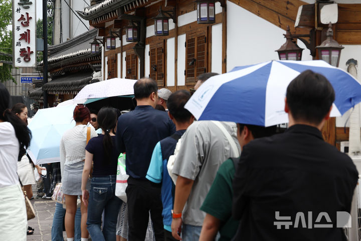 [서울=뉴시스] 고승민 기자 = 중복을 하루 앞둔 24일 서울의 한 삼계탕 음식점을 찾은 시민과 외국인 관광객이 줄지어 대기하고 있다. 2026.07.24. kkssmm99@newsis.com