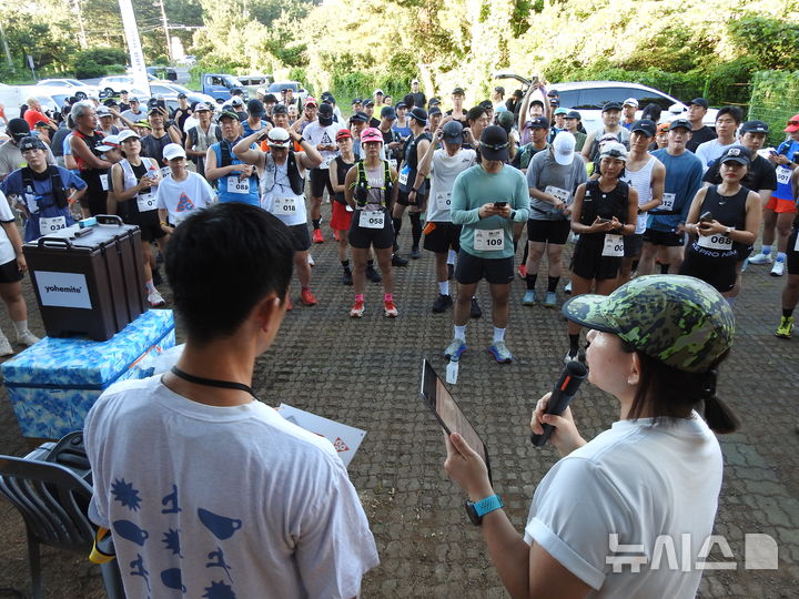 [제주=뉴시스] 김수환 기자 = 25일 오후 제주시 애월읍 궷물오름 주차장에서 제주 아웃도어 커뮤니티 '구보(goobo)'가 주관한 '노꼬메 나이트 트레일' 행사가 열린 가운데 참가자들이 주최측의 코스 설명을 듣고 있다. 2026.07.27. notedsh@newsis.com