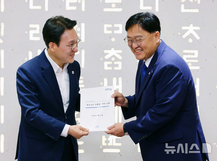 [세종=뉴시스] 배훈식 기자 = 더불어민주당 김민석(왼쪽) 당대표 후보가 27일 오전 세종시청을 찾아 조상호 시장으로부터 '행정수도 특별법' 제정 건의서를 받고 있다. 2026.07.27. dahora83@newsis.com