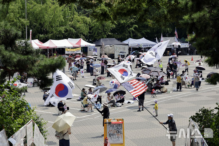 [서울=뉴시스] 최동준 기자 = 투표용지 부족 사태에 항의하는 개표소 시위가 54일째 이어지고 있는 지난달 28일 서울 송파구 올림픽공원 핸드볼 경기장 앞에서 시위 참가자들이 구호를 외치고 있다. 2026.07.28. photocdj@newsis.com