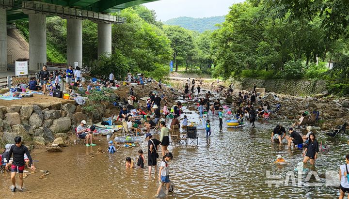 [양주=뉴시스] 김도희 기자 = 31일 오전 11시께 경기 양주시 송추계곡을 찾은 시민들이 무더위 속 휴식을 취하거나 아이들과 함께 물놀이를 즐기고 있다. 2026.07.31 kdh@newsis.com