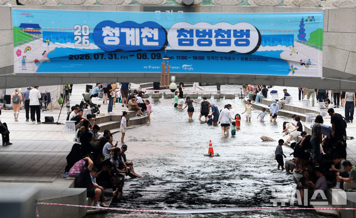 [서울=뉴시스] 이영환 기자 = 더위가 지속되고 있는 31일 서울 종로구 청계천에서 진행된 2026 청계천 첨벙첨벙에 참가한 시민들이 즐거운 시간을 보내고 있다. 청계천 첨벙첨벙은 청계폭포부터 광통교 120m 구간에서 이날부터 다음 달 9일까지 열린다. 오전 11시부터 오후 6시까지 물에 발을 담그고 쉴 수 있도록 의자와 테이블 등이 설치된다. 2026.07.31. 20hwan@newsis.com