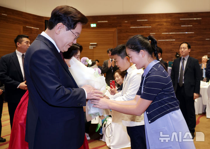 [프랑크푸르트=뉴시스] 김진아 기자 = 이재명 대통령과 김혜경 여사가 2일(현지 시간) 독일 프랑크푸르트의 한 호텔에서 열린 동포 오찬 간담회에서 화동에게 꽃다발을 받고 있다. 2026.08.02. bluesoda@newsis.com