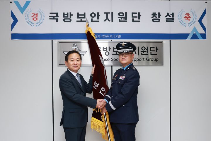 [서울=뉴시스] 이두희 국방부 차관이 3일 서울 용산구 국방보안지원단 창설 행사에 참석해 부단장 최진영 대령에게 부대기를 이양하고 있다. (사진=국방부 제공) 2026.08.03. photo@newsis.com *재판매 및 DB 금지
