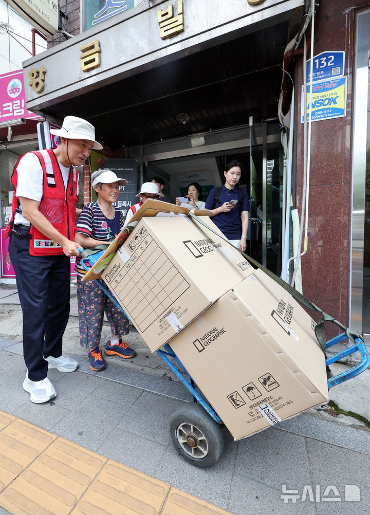 [서울=뉴시스] 김금보 기자 = 오세훈 서울시장이 4일 서울 용산구 효창동 일대 골목에서 폐지 수집 어르신을 도와 손수레를 밀고 있다. 2026.08.04. kgb@newsis.com