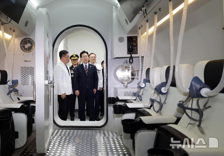 [음성=뉴시스] 조성봉 기자 = 이재명 대통령이 11일 충북 음성군 국립소방병원 고압산소치료실에서 최일국 국립소방병원 응급의학과 교수에게 보고를 받고 있다. 2026.08.11. suncho21@newsis.com