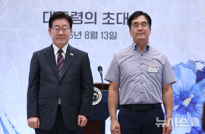 [서울=뉴시스] 조성봉 기자 = 이재명 대통령이 13일 청와대 영빈관에서 열린 국가유공자 및 보훈 가족 초청 오찬 행사에서 2023년 혹한기 훈련 중 사망한 고 최민서 일병 아버지인 최재우 씨에게 태극기 배지를 증정하고 기념 촬영을 하고 있다. 2026.08.13. suncho21@newsis.com