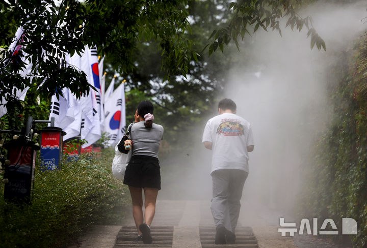 [대구=뉴시스] 이무열 기자 = 대구지역에 폭염주의보가 발효된 13일 대구 중구 청라언덕에 설치된 쿨링포그 아래로 시민들이 이동하고 있다. 2026.08.13. lmy@newsis.com