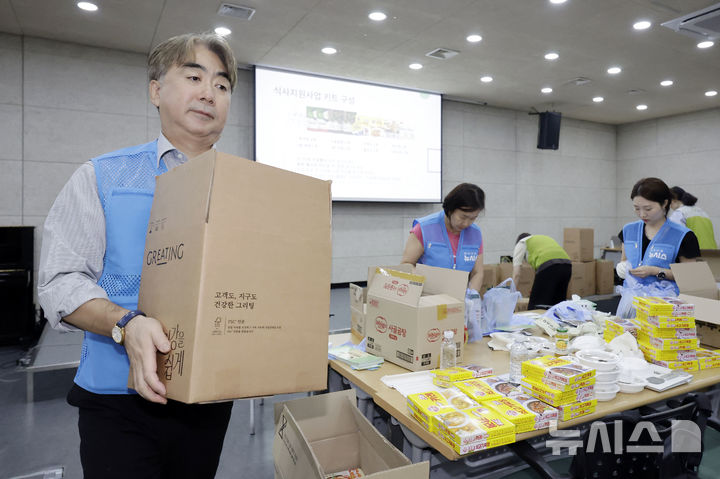 [서울=뉴시스] 최동준 기자 = 뉴시스 염영남 대표이사를 비롯한 임직원과 글로벌 아동권리 전문 NGO 굿네이버스가 13일 서울 영등포구 굿네이버스 회관에서 '얘들아 밥먹자' 키트 포장 봉사활동을 하고 있다.굿네이버스 식사지원사업 '얘들아 밥먹자'는 방학 중 결식 위험에 놓인 전국 취약계층 아동에게 도시락과 식료품, 밀키트 등을 전달하는 사업이다. 2026.08.13. photocdj@newsis.com