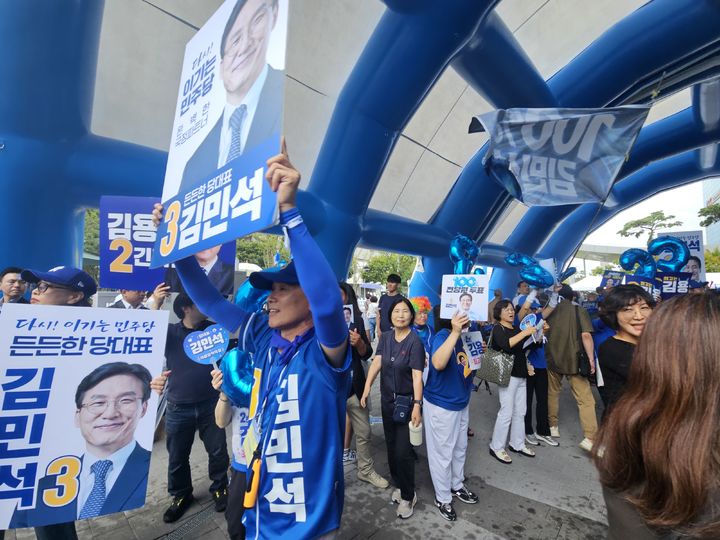 [대전=뉴시스]한재혁 기자 = 17일 김민석 더불어민주당 당대표 후보의 지지자들이 대전 대전컨벤션센터에서 열린 3차 전국당원대회 개최를 앞두고 응원전을 펼치고 있다. 2026.08.17. saebyeok@newsis.com *재판매 및 DB 금지