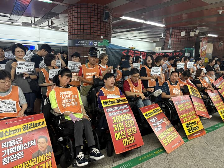 [서울=뉴시스] 김나연 수습기자 = 전국장애인차별철폐연대가 18일 오전 8시부터 수도권 전철 서울역에서 2027년 장애인권리예산 보장을 촉구하며 '72차 출근길지하철탑니다' 시위를 진행하고 있다. 2026.08.18. photo@newsis.com *재판매 및 DB 금지