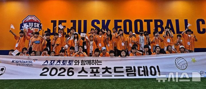 [서울=뉴시스]참가자들이 직접 만든 응원 깃발을 들고, 제주SK-포항스틸러스전을 관람하기 전 스포츠드림데이 기념 촬영에 임하고 있다. (사진=한국스포츠레저 제공)