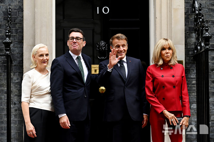 Britain's Prime Minister Andy Burnham and his wife, Marie-France van Heel, left, pose for photos with France's President Emmanuel Macron and his wife Brigitte Macron ahead of a bilateral meeting at 10 Downing Street in London, Thursday, Sept. 3, 2026. (Leon Neal/Pool Photo via AP)