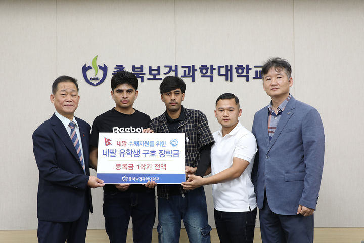 강석규 대외부총장(왼쪽)이 3일 네팔 국적 유학생들에게 장학금을 전달하고 기념촬영을 하고 있다. (사진=충북보건과학대학교 제공) *재판매 및 DB 금지