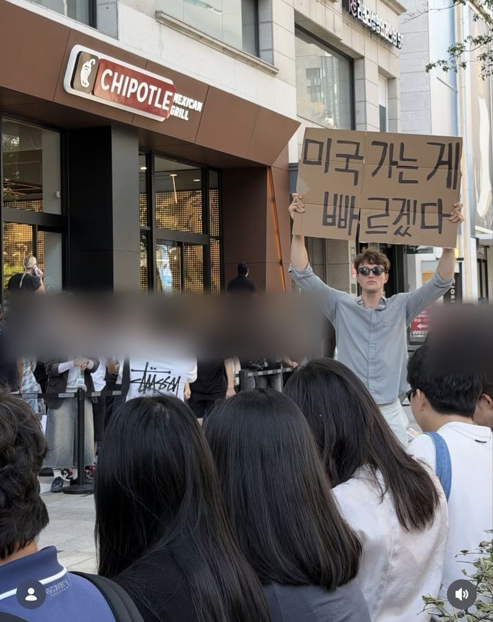 [서울=뉴시스] 인플루언서 아담 노박이 서울 서초구 치폴레 강남점 앞에서 "미국 가는 게 빠르겠다"라고 적힌 종이박스를 들고 있다. (사진=인스타그램 @its_adam_novak 캡처) *재판매 및 DB 금지