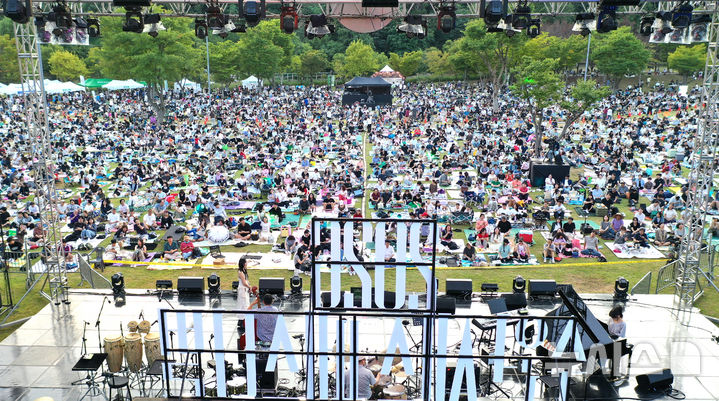 [수원=뉴시스] 김종택 기자 = '2026 수원재즈페스티벌' 둘째날인 19일 오후 경기 수원시 광교호수공원 재미난 밭에서 잔디광장을 가득 메운 시민들이 돗자리에 앉아 선선한 가을 공기를 맞으며 흥겨운 재즈 선율을 즐기고 있다. 2026.09.19. jtk@newsis.com