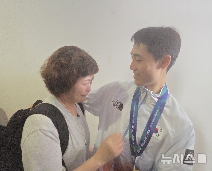 [나고야(일본)=뉴시스] 이준석(오른쪽)이 2026 아이치·나고야 아시안게임 테크볼 남자 단식에서 금메달을 차지한 뒤 어머니와 함께 기쁨을 나누고 있다. 2026.09.20.