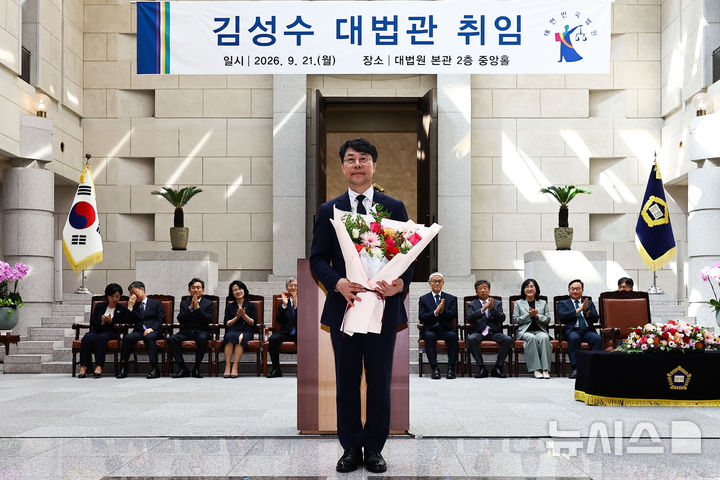 [서울=뉴시스] 홍효식 기자 = 김성수 신임 대법관이 21일 서울 서초구 대법원에서 열린 신임 대법관 취임식에서 꽃을 받고 있다. (공동취재) 2026.09.21. photo@newsis.com