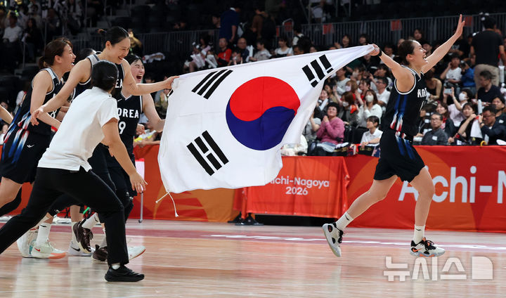[나고야(일본)=뉴시스] 김금보 기자 = 26일 오후(현지 시간) 일본 아이치현 나고야시에서 열린 2026 아이치·나고야 아시안게임 여자 농구 결승 한국과 일본의 경기, 75-70으로 일본을 꺾고 금메달을 확정지은 한국 강이슬과 최이샘이 태극기를 들고 질주하고 있다. 2026.09.26. kgb@newsis.com