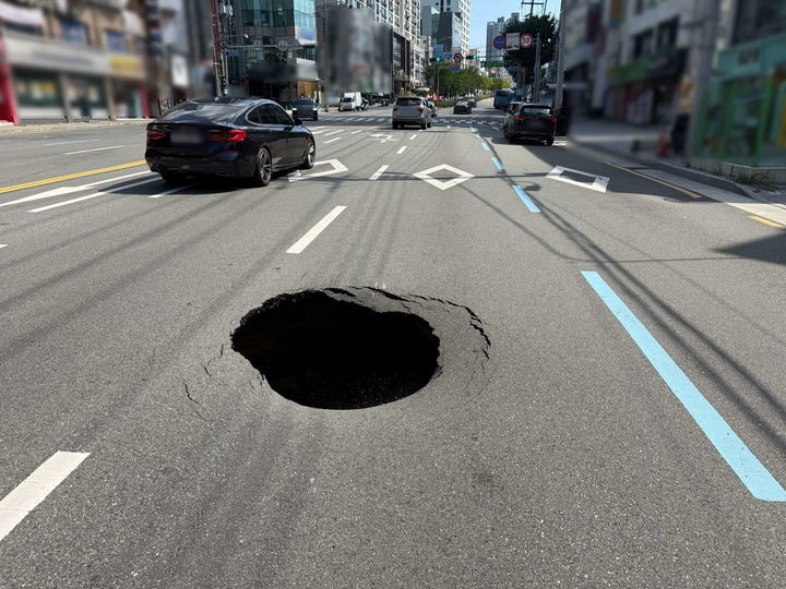 [부산=뉴시스] 30일 오후 1시15분께 부산 사하구 하단동의 한 도로에서 지름 1m, 깊이 1.8m 크기의 땅꺼짐이 발생했다. (사진=부산 사하경찰서 제공) 2026.09.30. photo@newsis.com *재판매 및 DB 금지