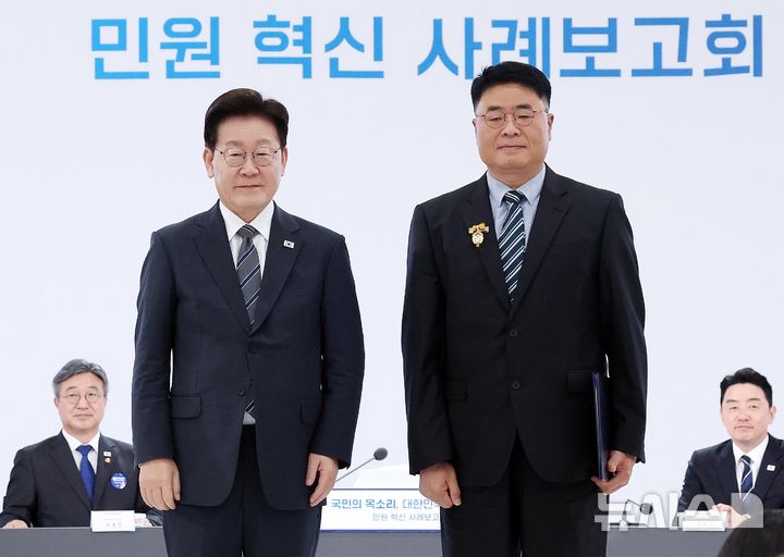 [세종=뉴시스] 조성봉 기자= 이재명 대통령이 2일 세종특별자치시에서 열린 '국민의 목소리, 대한민국을 바꾼다' 민원 혁신 사례보고회에서 김정환 경기 화성시 주차시설팀장에게 대통령 표창을 수여하고 기념촬영을 하고 있다. 2026.10.02. suncho21@newsis.com