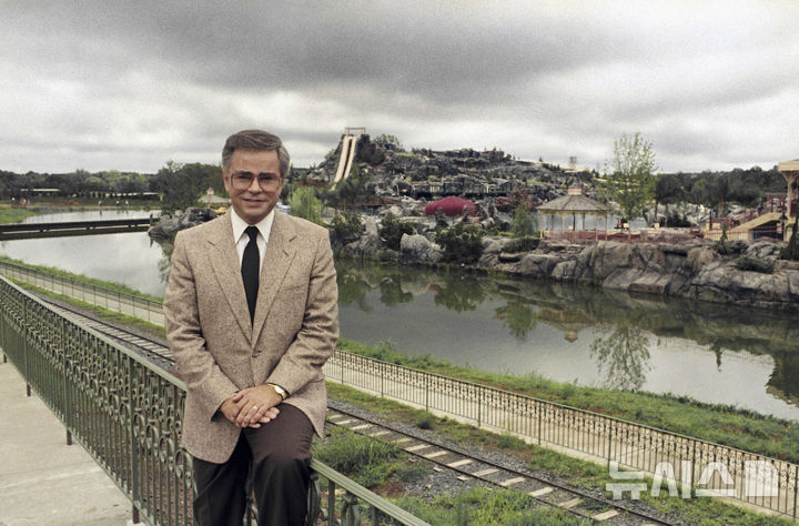 FILE - Television evangelist Jim Bakker poses in front of the Water Park in Fort Mill, S.C., one of the attractions at his Heritage USA, March 19, 1987. (AP Photo/Lou Krasky, File) CORRECTION: Location corrected from Columbia to Fort Mill