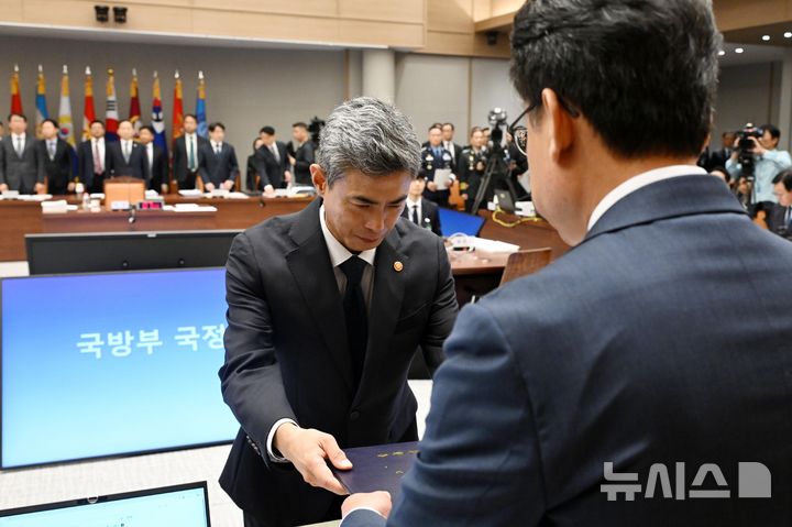 [서울=뉴시스] 국회사진기자단 = 강신철 국방부 장관이 7일 서울 용산구 국방부에서 열린 국회 국방위원회의 국방부에 대한 국정감사에 출석해 증인 선서를 마친 뒤 진성준 국방위원장에게 선서문을 제출하고 있다. 2026.10.07. photo@newsis.com
