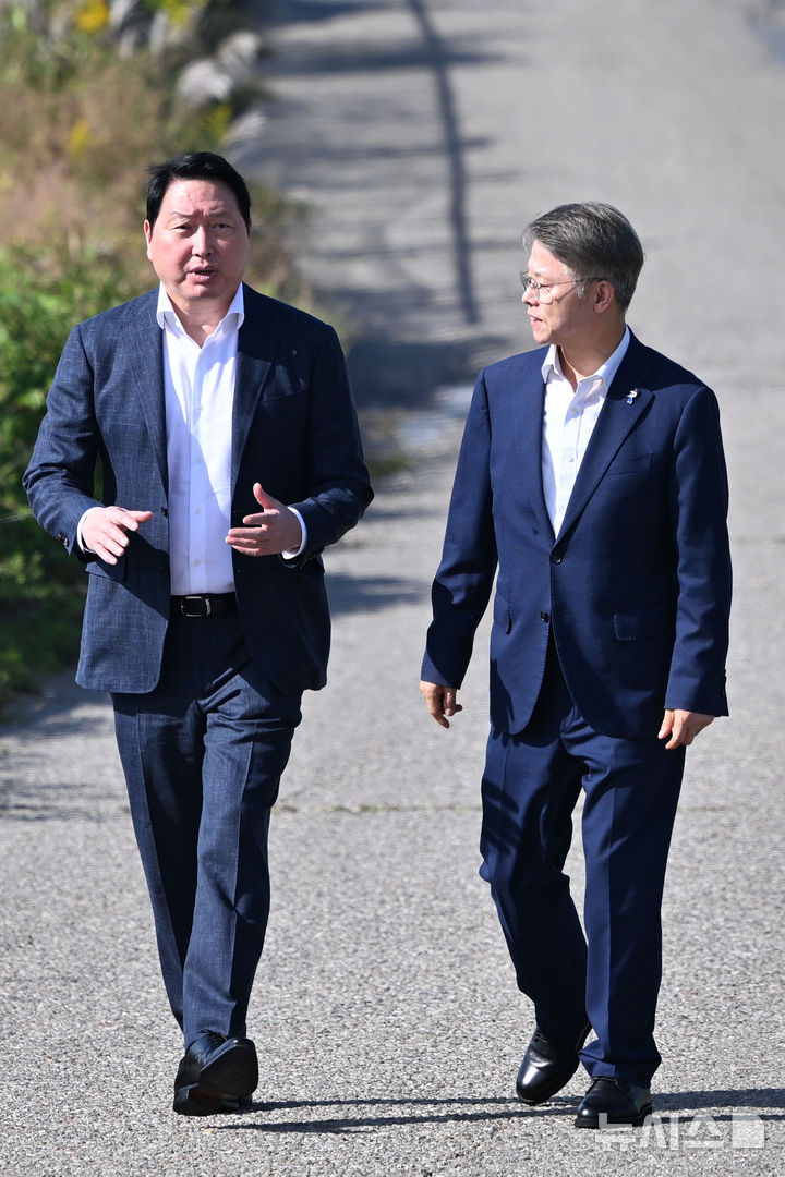 [전남광주=뉴시스] 이영주 기자 = 최태원(왼쪽) SK그룹 회장과 민형배 전남광주통합특별시장이 9일 오후 전남광주 서구 벽진동 주변 광주군공항 '호남 반도체 클러스터' 조성 예정지를 둘러보며 대화하고 있다. 2026.10.09. leeyj2578@newsis.com