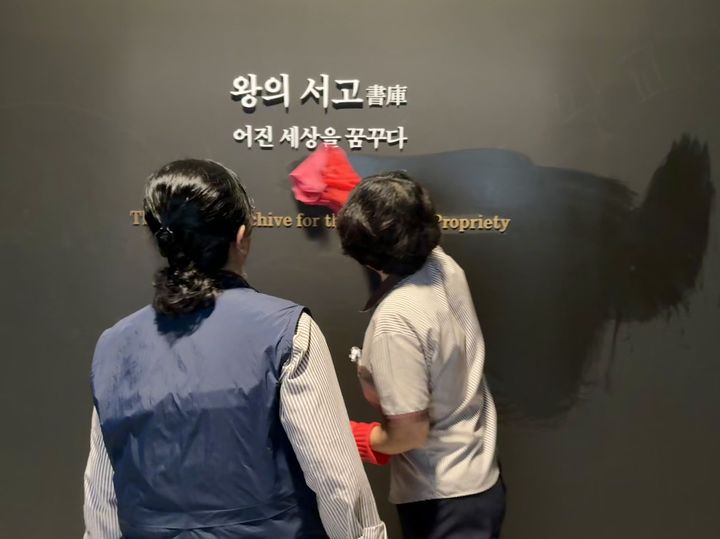 [서울=뉴시스] 한이재 기자 = 12일 서울 용산구 국립중앙박물관에서 관계자들이 상설전시관 2층 서화관 외규장각 의궤실에 새겨진 낙서를 닦고 있다. 2026.10.12. nowone@newsis.com *재판매 및 DB 금지