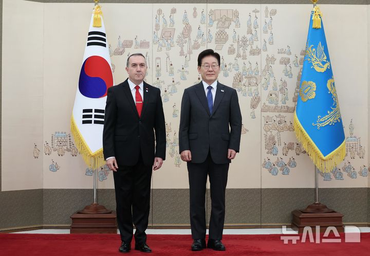 [서울=뉴시스] 조성봉 기자 = 이재명 대통령이 12일 청와대에서 열린 주한대사 신임장 제정식에서 도나타스 타물라이티스 주한튀르키예대사에게 신임장을 받고 기념 촬영을 하고 있다. (청와대통신사진기자단) 2026.10.12. suncho21@newsis.com