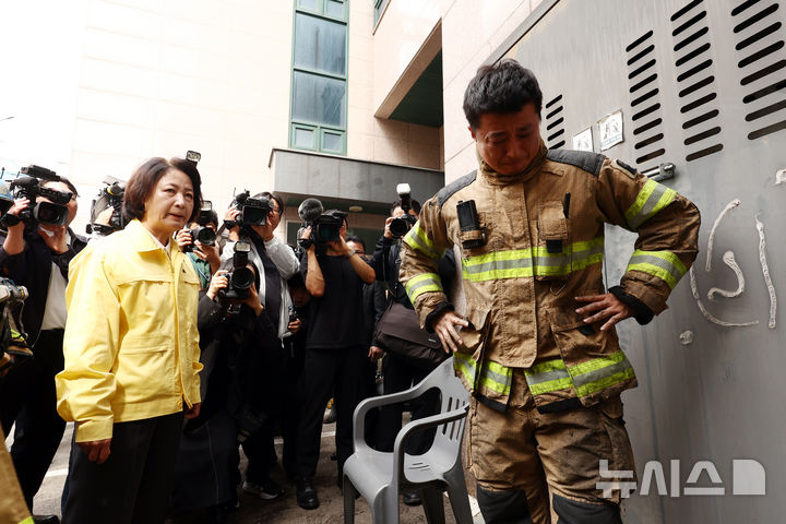 [부천=뉴시스] 고승민 기자 = 16일 경기도 부천시 오정구의 한 도장공장 화재 현장에서 한 소방관이 눈물을 흘리고 있다. 추미애 경기도지사가 위로의 말을 전하고 있다. 2026.10.16. kkssmm@newsis.com