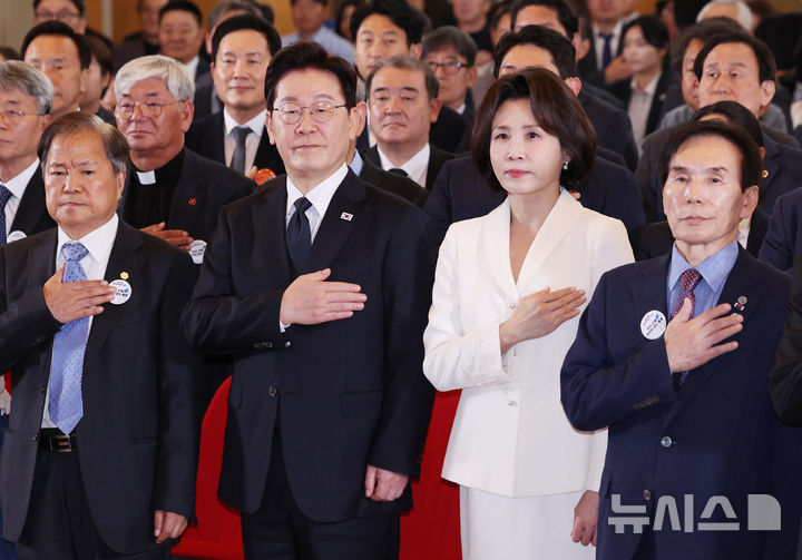 [부산=뉴시스] 김진아 기자 = 이재명 대통령과 김혜경 여사가 16일 부산시청에서 열린 제47주년 부마민주항쟁 기념식에서 국기에 대한 경례를 하고 있다. 2026.10.16. bluesoda@newsis.com