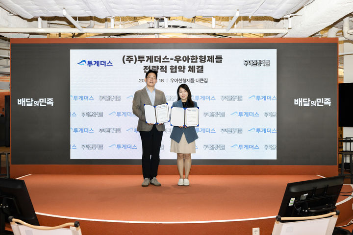 [서울=뉴시스] 16일 서울 송파구 우아한형제들 사옥에서 박민아 우아한형제들 배민스토어사업실장(오른쪽)과 서형석 투게더스 대표이사가 양사 전략적 협약 체결을 기념해 사진 촬영을 하고 있다. (사진=우아한형제들 제공) 2026.10.18. photo@newsis.com *재판매 및 DB 금지