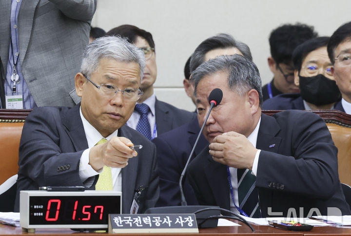 [서울=뉴시스] 김근수 기자 = 김동철(왼쪽) 한국전력공사 사장이 19일 오전 서울 여의도 국회에서 열린 기후에너지환경노동위원회 국정감사에서 김성진 한국전력거래소 이사장과 이야기를 나누고 있다 . 2026.10.19. ks@newsis.com