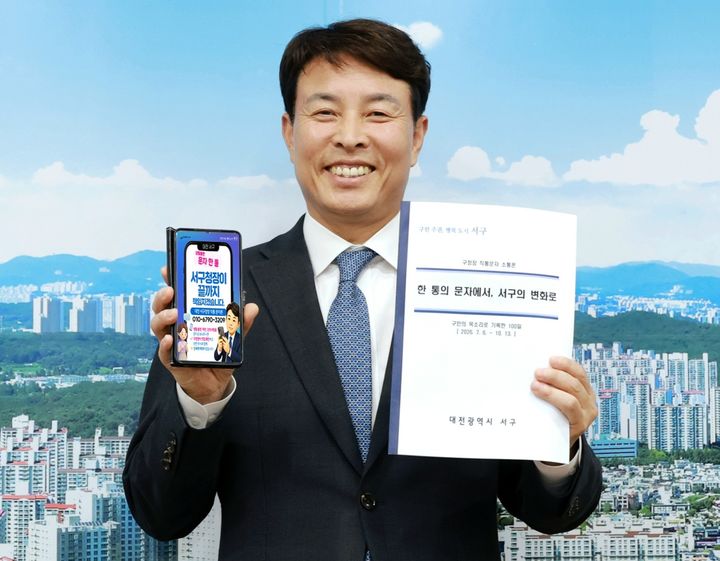 [대전=뉴시스] 전문학 대전 서구청장이 직통문자 소통폰 성과공유 결과집을 들고 기념사진을 찍고 있다. (사진= 서구청 제공) *재판매 및 DB 금지