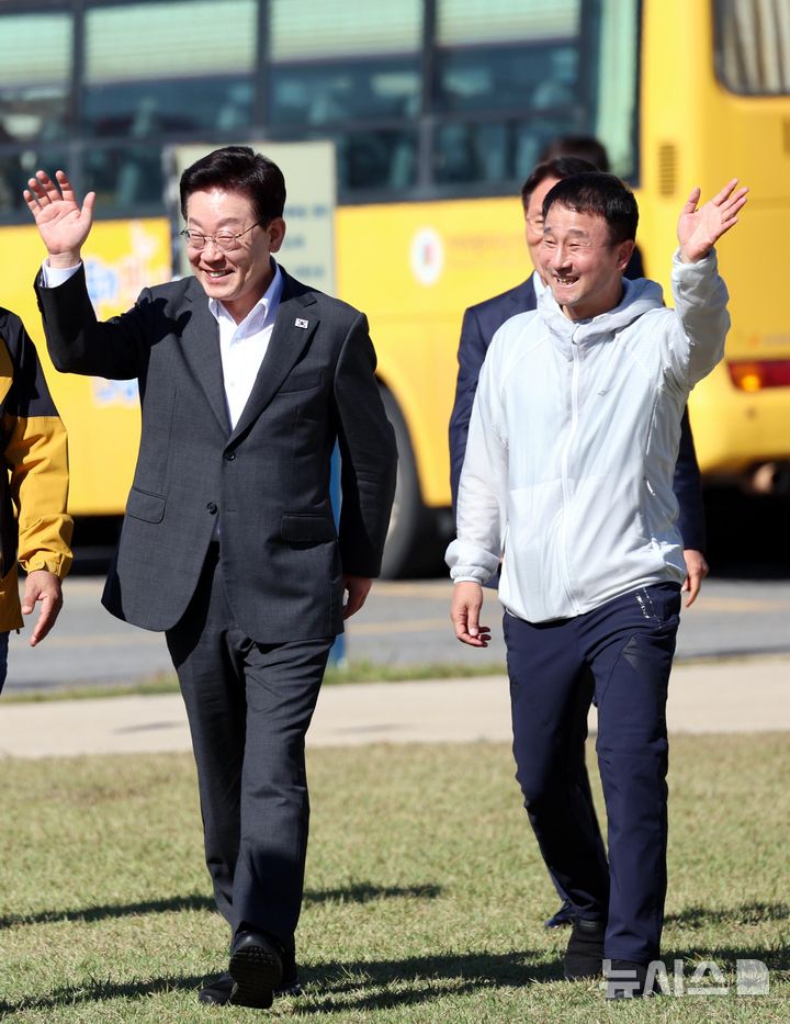 [익산=뉴시스] 김진아 기자 = 이재명 대통령과 한병도 더불어민주당 원내대표 22일 전북 익산 왕궁초등학교에서 열린 가을 행복학교 체육한마당에 입장하며 학생들에게 손 인사를 하고 있다. 2026.10.22. bluesoda@newsis.com