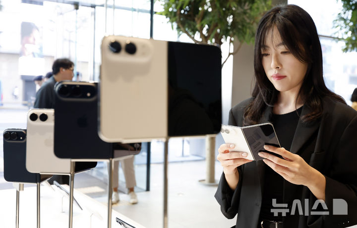 [서울=뉴시스] 김혜진 기자 = 애플의 첫 폴더블폰 아이폰 듀오가 정식 출시된 23일 서울 중구 명동 애플스토어에서 아이폰을 구매하려는 고객들이 제품을 살펴보고 있다. 2026.10.23. jini@newsis.com